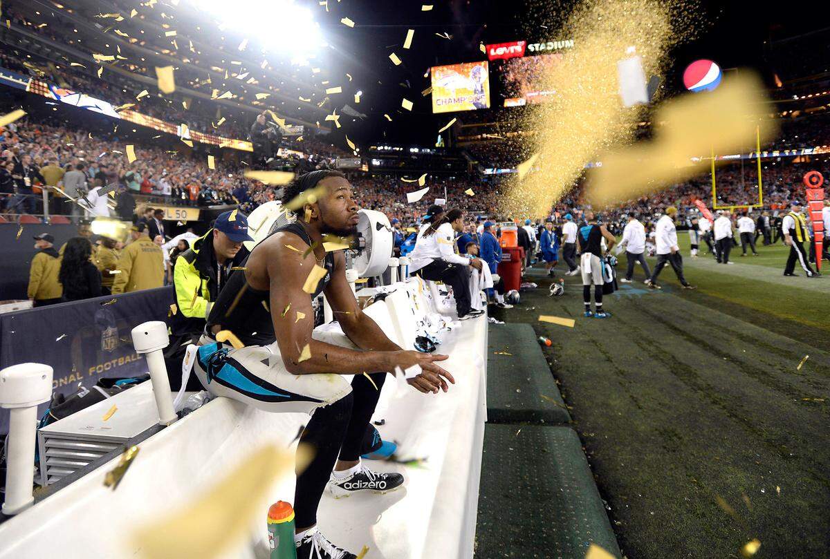 Josh Norman watches through confetti as the Denver Broncos celebrate winning Super Bowl 50.