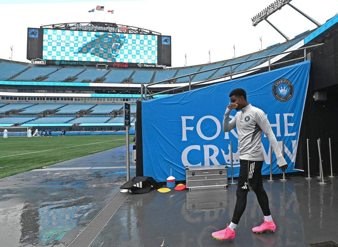 The Jumbotron at Bank of America Stadium displays a Carolina Panthers logo as a member of Charlotte FC arrives for Monday’s practice. The Panthers hosted the Buffalo Bills on Sunday while Charlotte FC will host New York City FC in an MLS playoff opener Tuesday. Work crews worked throughout Sunday and Monday to ready the stadium for the transformation from a football venue to hosting soccer.