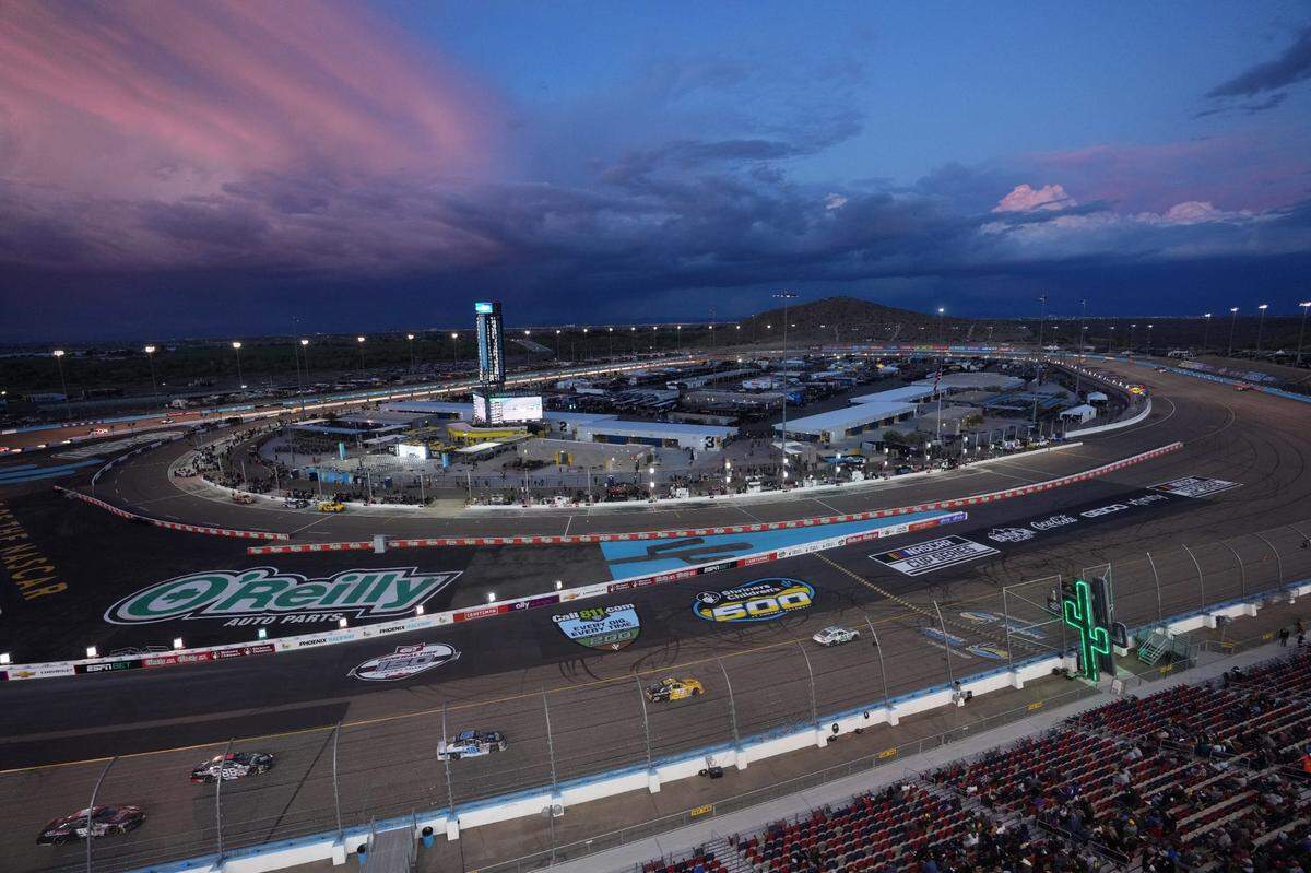The ARCA Series drivers race as the sun sets at Phoenix Raceway.
