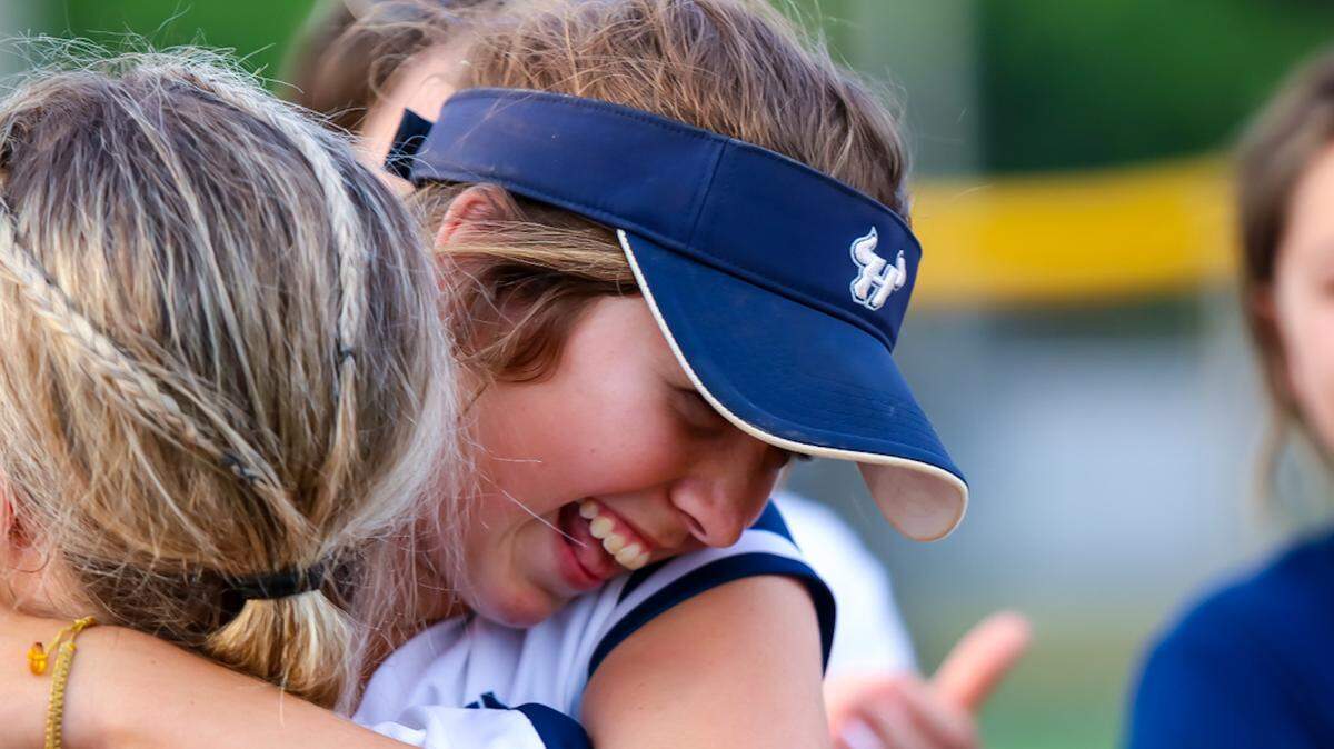 Hickory Ridge players embrace after beating Marvin Ridge in the first round of playoffs
