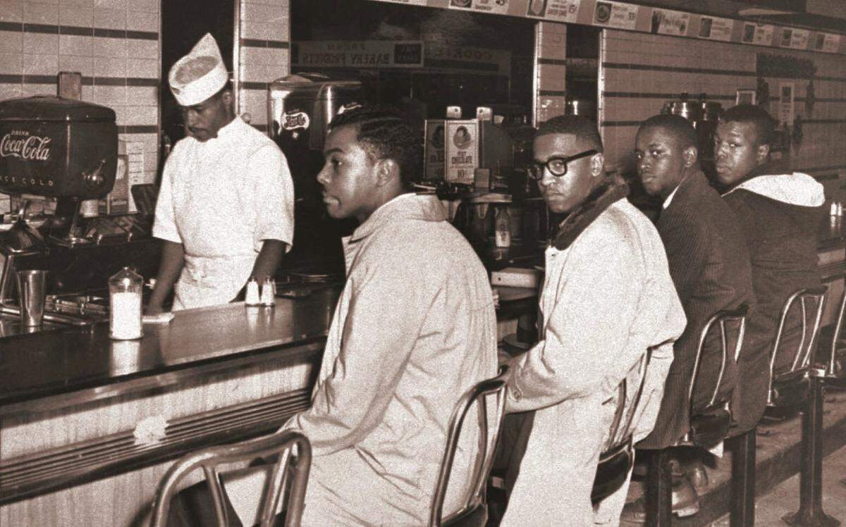 A group of 20 A&T College students sat at lunch counters without being served at the downtown F.W. Woolworth Co. store in Greensboro, N.C., in this 1960 file photo. From left are Joseph McNeil and Franklin McCain, two of the four leaders in the movement, and Billy Smith and Clarence Henderson.