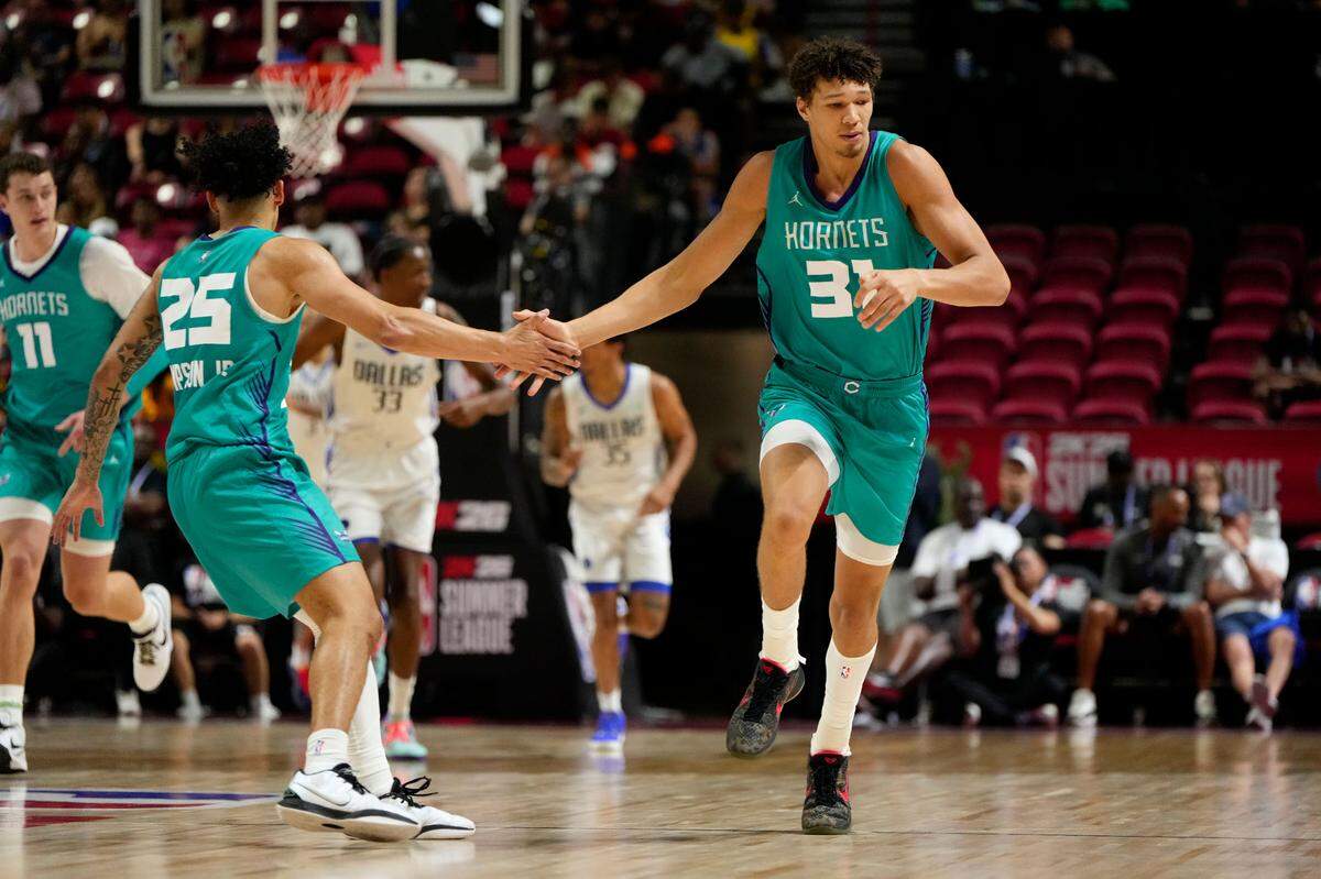 Charlotte Hornets forward Tidjane Salaun (31) celebrates with guard KJ Simpson (25) after scoring against the Dallas Mavericks during the first half of a NBA basketball game at the Thomas & Mack Center.