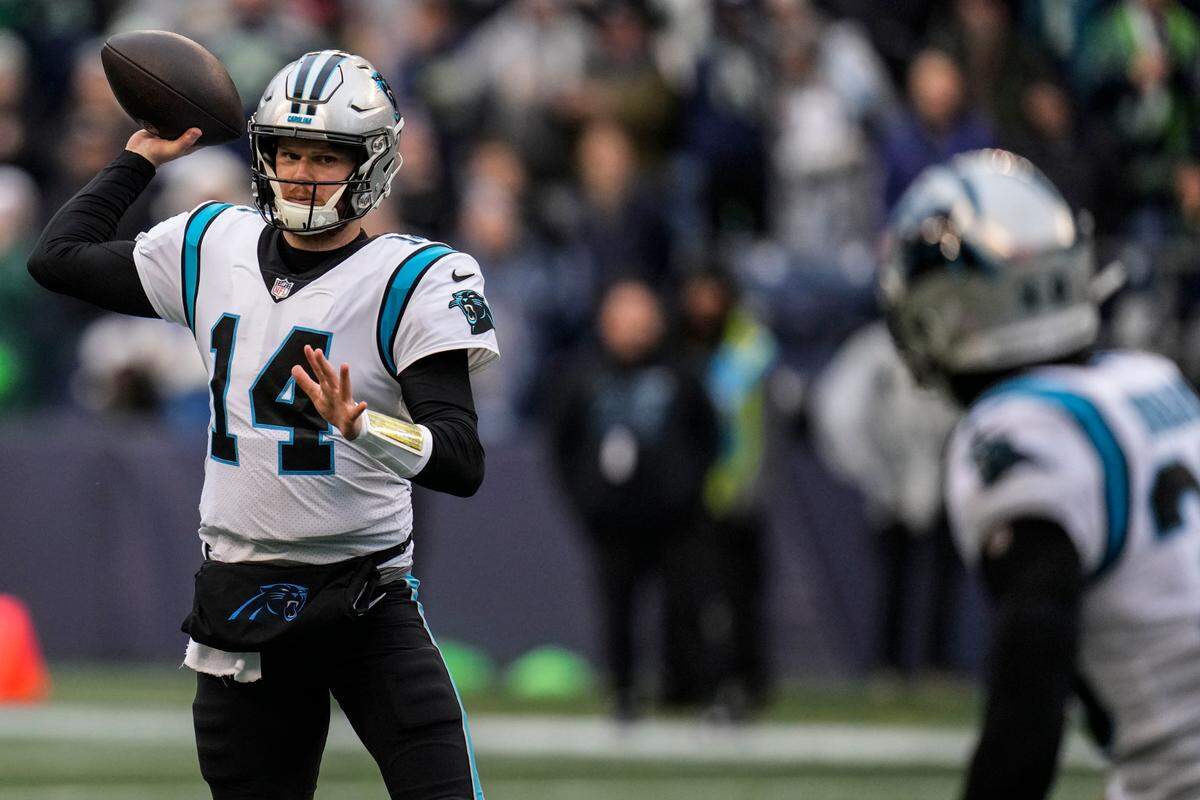 Carolina Panthers quarterback Sam Darnold (14) passes the ball against the Seattle Seahawks during the first half of an NFL football game, Sunday, Dec. 11, 2022, in Seattle. (AP Photo/Gregory Bull)