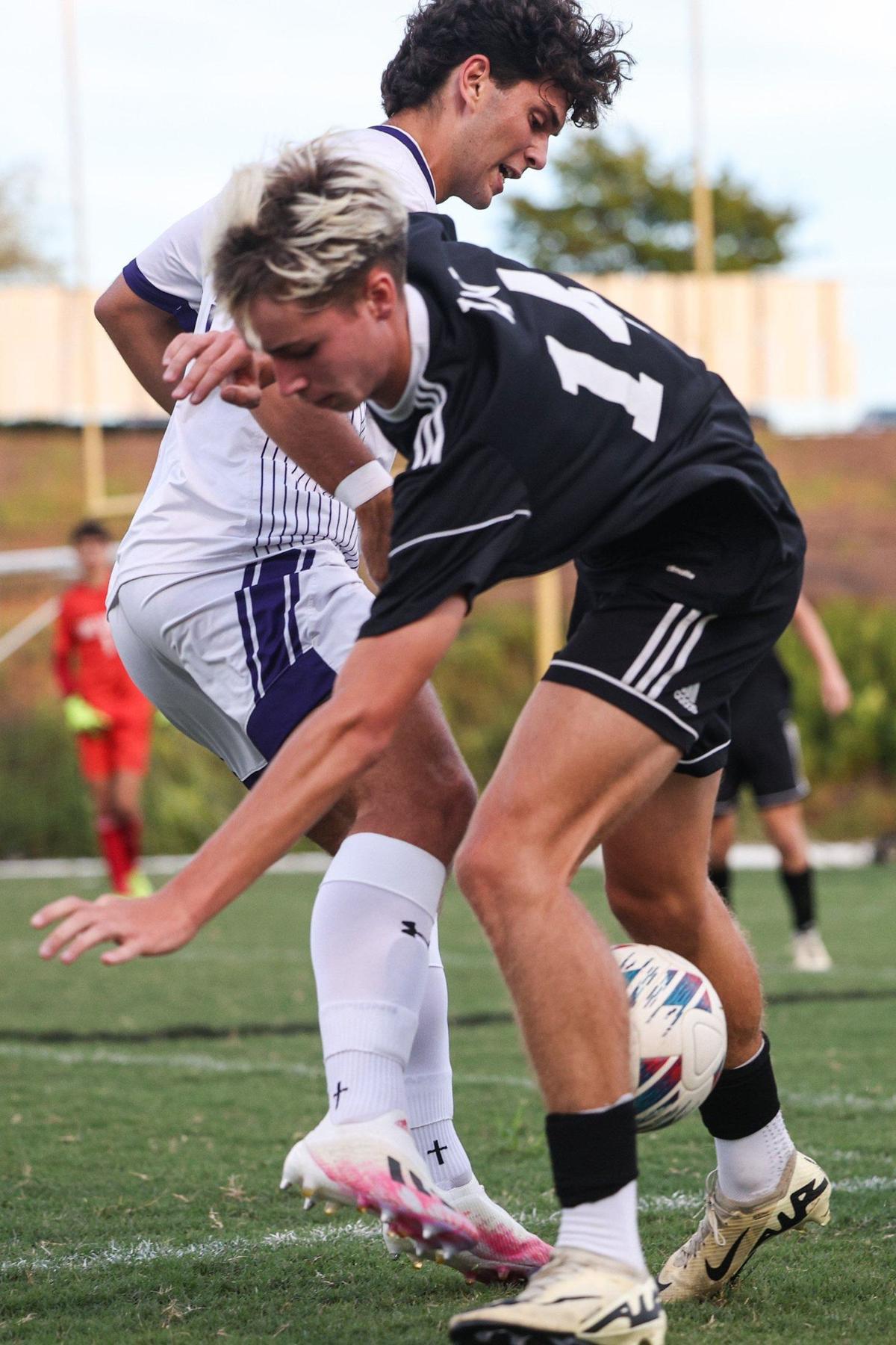 Ardrey Kell’s Reed Shunkwiler, left, kicks the ball away from Lake Norman’s Jackson Wren during the game in Mooresville, NC on Tuesday, September 3, 2024.