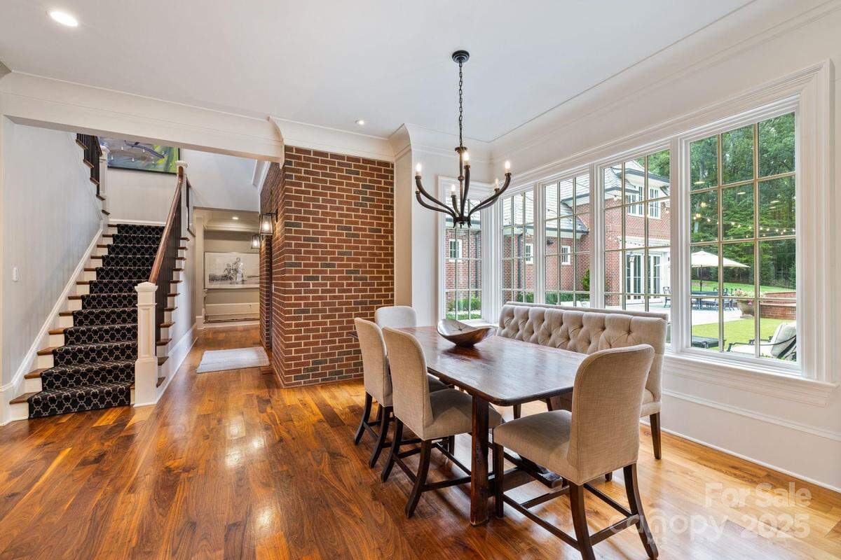 This dining area in Jamie McMurray’s mansion affords views of the pool area and surrounding woods.  