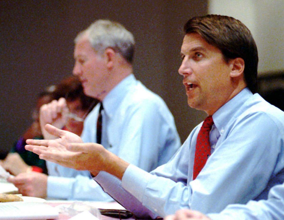 In 1993, then-Charlotte City Council member Pat McCrory (right) speaks at a council meeting.