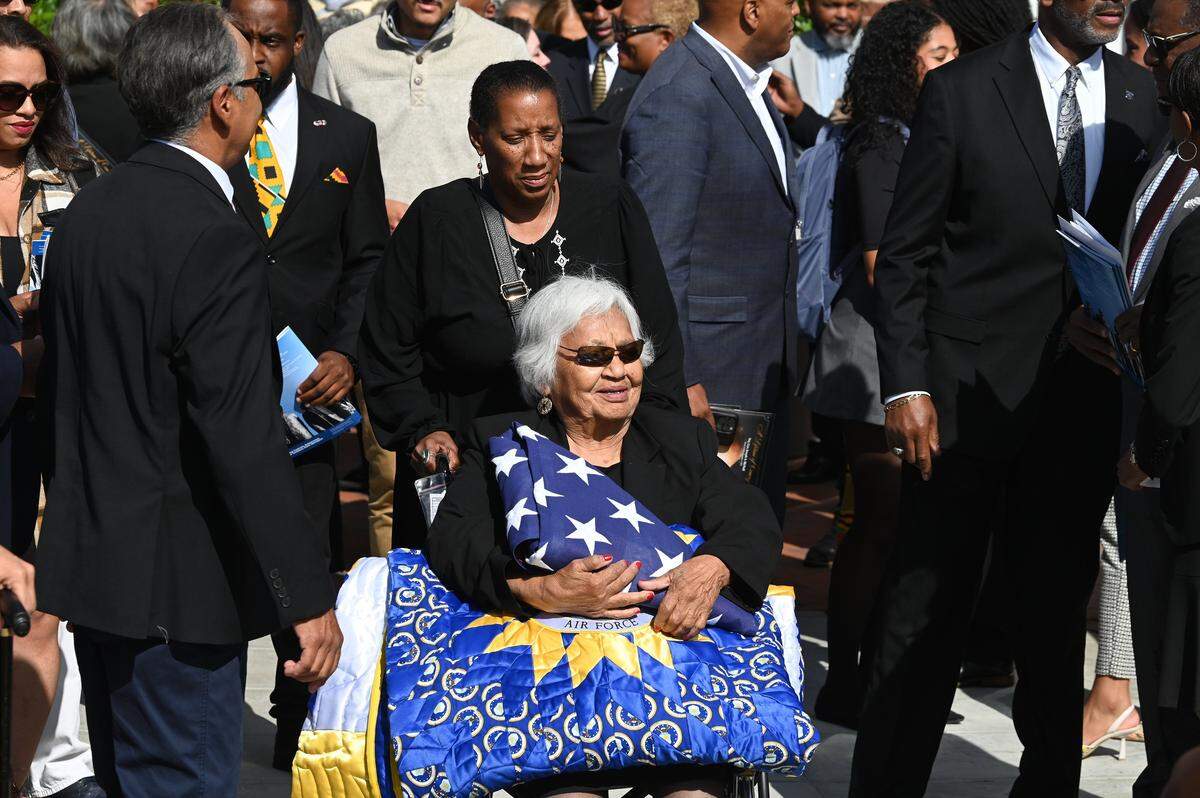 Ina Mae Brown McNeil, the widow of Maj. Gen. Joseph McNeil, held the American flag and drapery that covered his casket during a memorial service at Harrison Auditorium on the campus of North Carolina A&T State University in Greensboro, NC., on Thursday, September 11, 2025. Maj. Gen. Joseph McNeil was one of four young men who sat at a segregated Woolworth lunch counter in Greensboro, North Carolina, on February 1, 1960, during a sit-in. He and three other young men, including Frank McCain, Ezell Blair Jr. (who later became Jibreel Khazan), and David Richmond, became known as the “Greensboro Four.” 