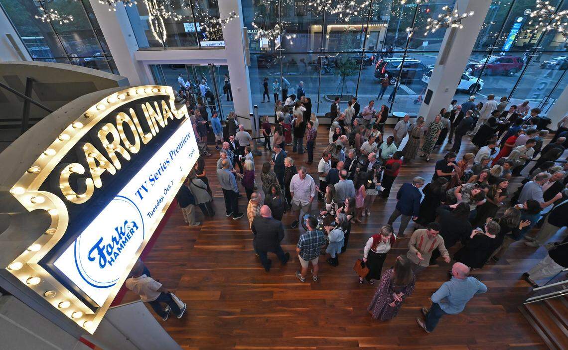 Attendees gather in the lobby of the Carolina Theatre prior to the premiere of "Fork & Hammer" on Tuesday night.