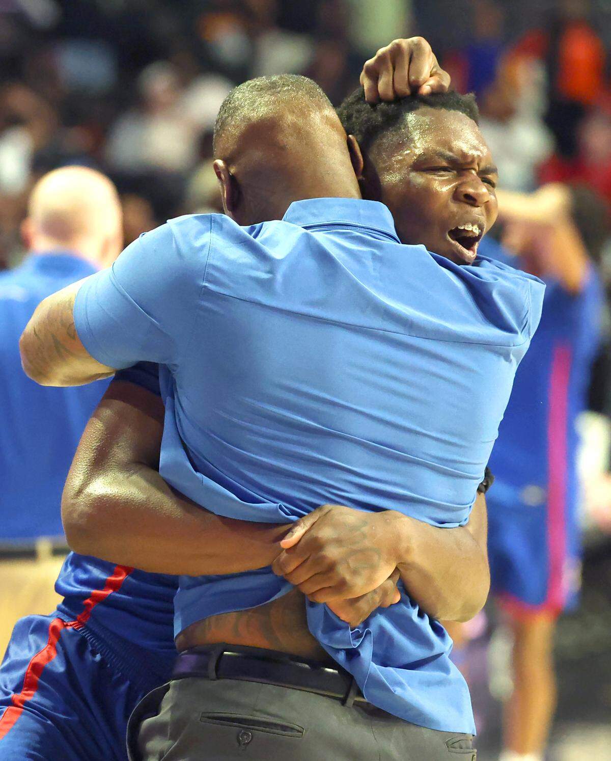 North Meck Vikings Exzavier Young celebrates the team’s victory with a member of the coaching staff following the teams 59-56 victory over New Hanover in the boys NCHSAA 4A State Championship game at Lawrence Joel Veterans Coliseum in Winston-Salem, NC on Saturday, March 15, 2025.