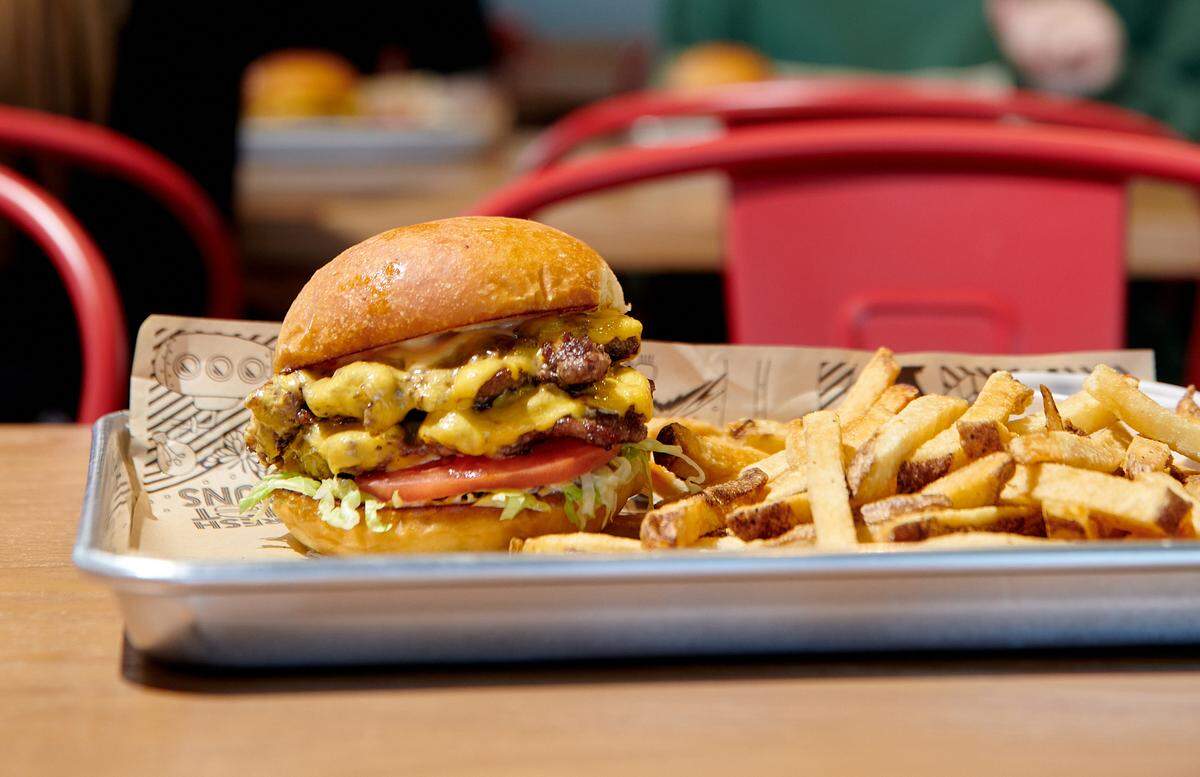 The Mooyah Double Cheeseburger made with double Certified Angus beef, American cheese, lettuce, tomato and MOOYAH Sauce on a potato bun.