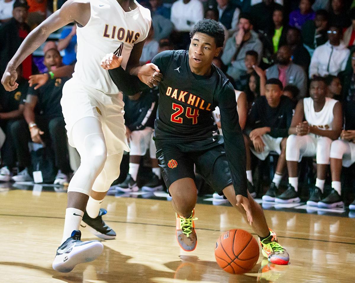 Oak Hill’s Cam Thomas (24) drives the baseline during early 1st half action.