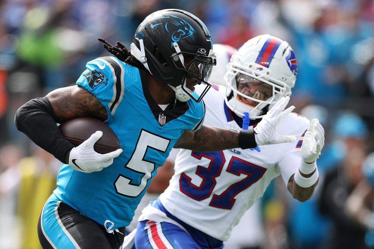 Carolina’s Rico Dowdle runs the ball against Buffalo cornerback Jordan Hancock in Sunday’s first quarter at Bank of America Stadium.