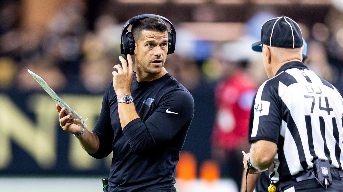 Carolina Panthers head coach Dave Canales talks to down judge Derick Bowers (74) on a time out against the New Orleans Saints during the first half at Caesars Superdome.