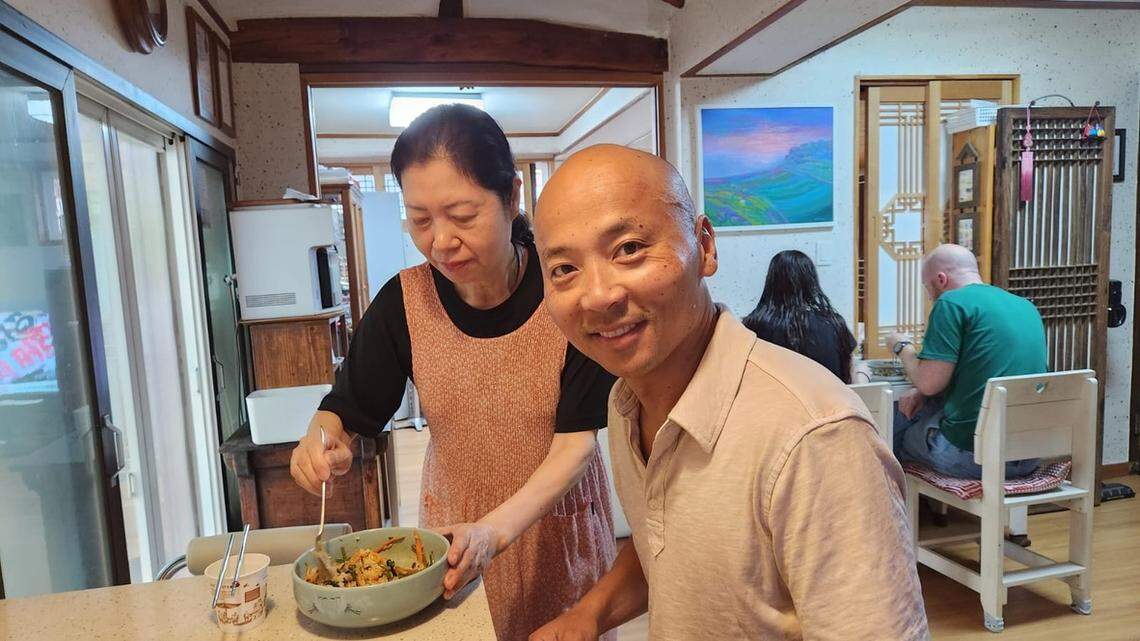 Mrs. Lee mixes up the bibimbap breakfast she prepared for Théoden Janes on the first morning of his stay at the guesthouse she helps run.