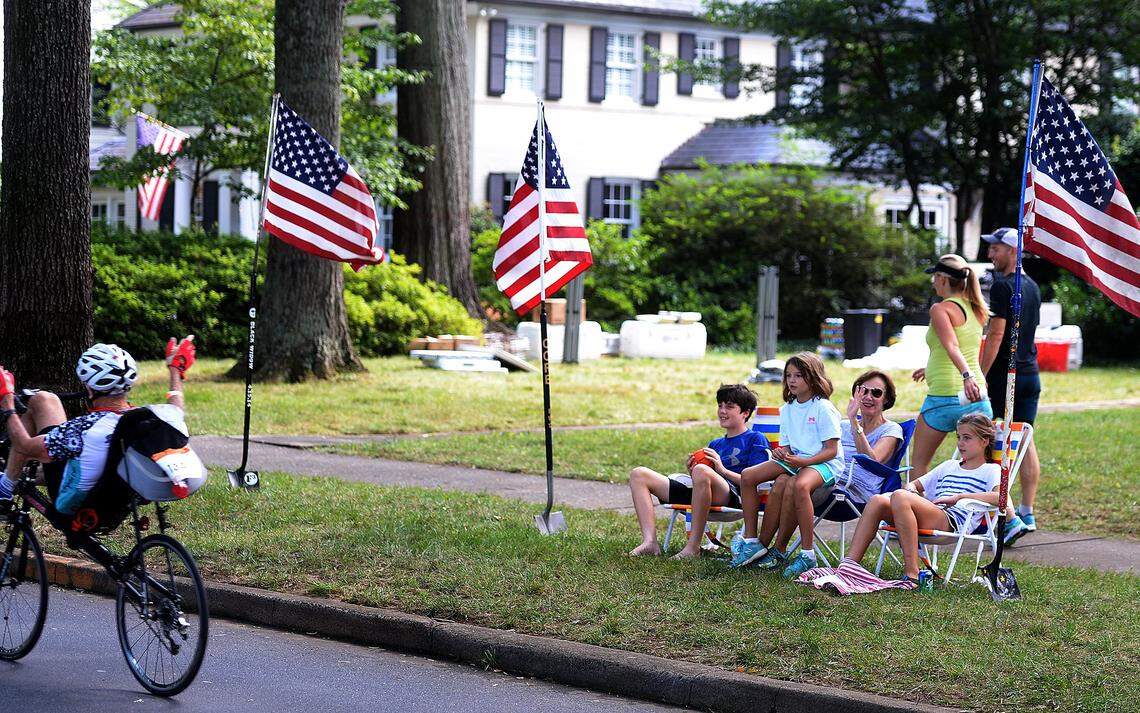 Spectators wave to cyclists on Queens Road West during 24 Hours of Booty in 2017.