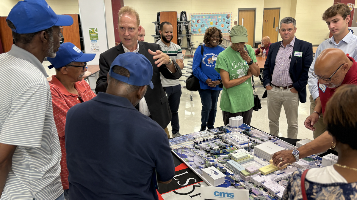 Second Ward High School alumni and community members talk on Wednesday June 27, 2028 at West Charlotte High School with architects and engage with campus site models at the community information meeting.