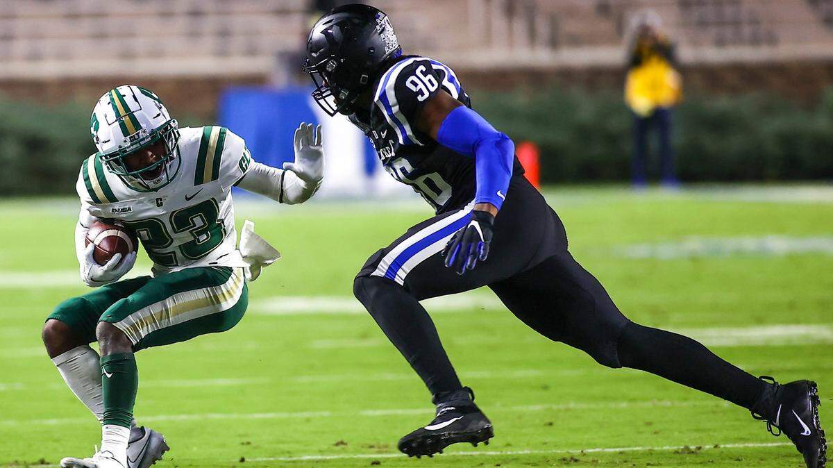 Charlotte wide receiver Micaleous Elder (23) runs with the ball while Duke defensive end Chris Rumph II (96) chases him during an NCAA college football game Saturday, Oct. 31, 2020, in Durham, N.C. (Jaylynn Nash/Pool Photo via AP)