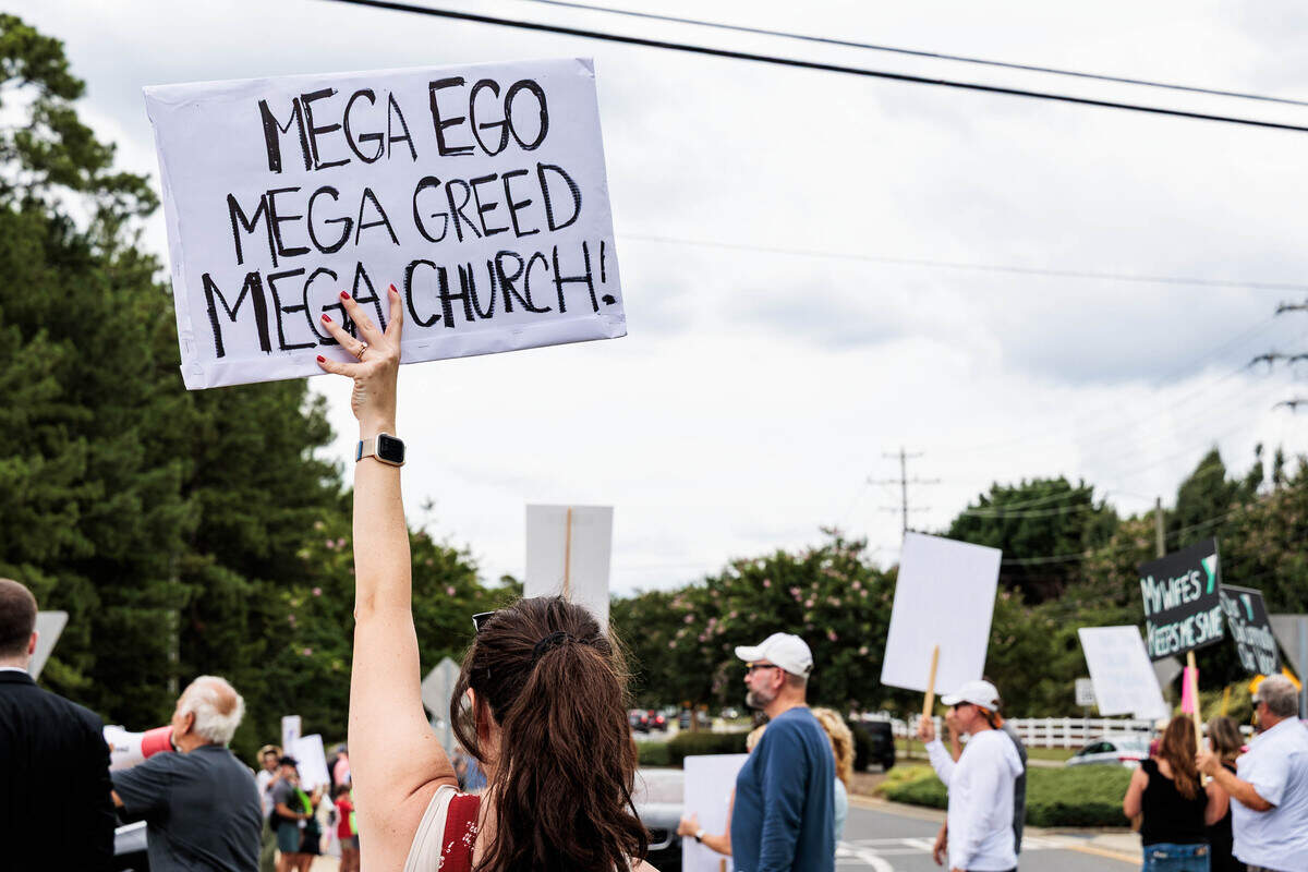 Joscelyne Hauserman protests the sale of the Morrison Family YMCA campus in Ballantyne to Moments of Hope Church on Sunday, July 12, 2026. “This is one of the most accepting places in Charlotte,” Hauserman said about the Y. “Everyone is welcome. Those are the principles Jesus would actually stand for.”