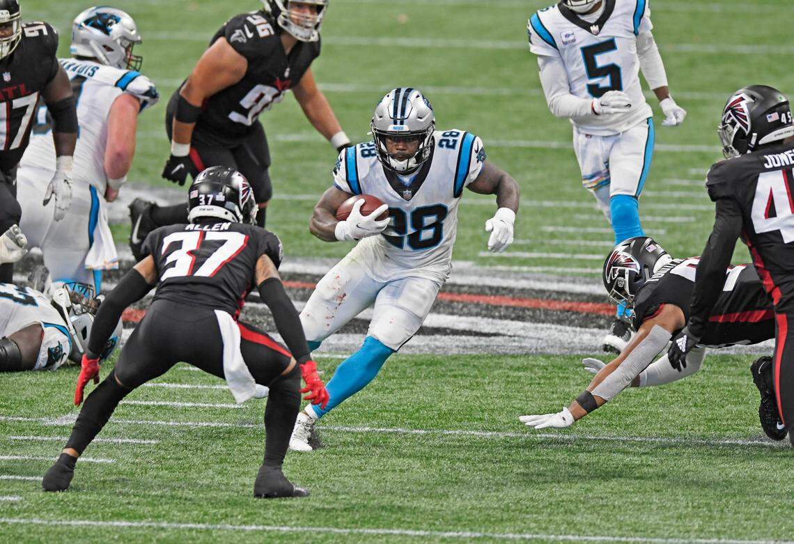 Carolina Panthers running back Mike Davis (28) gets running room against Atlanta Falcons free safety Ricardo Allen (37) during the fourth quarter at Mercedes-Benz Stadium in Atlanta, GA on Sunday, October 11, 2020. The Panthers won 23-16.