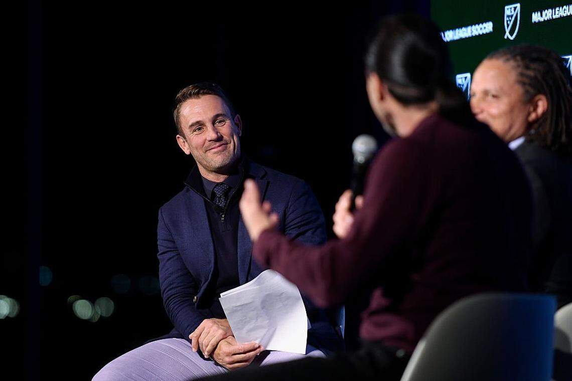 Apple TV MLS Season Pass talent Taylor Twellman hosts a panel with former players Cobi Jones and Marcelo Balboa during the MLS Commissioner State of the League Address at Audi Field on December 04, 2025 in Washington, DC.