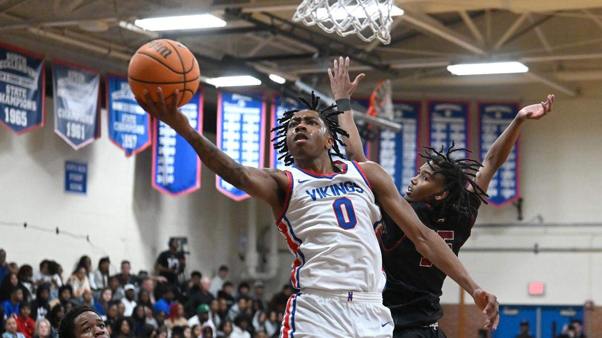North Meck’s Isaiah Evans, center, drives to the basket for two-points as Mallard Creek’s Brenden Ridge, right, looks on during first half action on Friday, February 2, 2024 at North Meck High. North Meck defeated Mallard Creek 108-64.