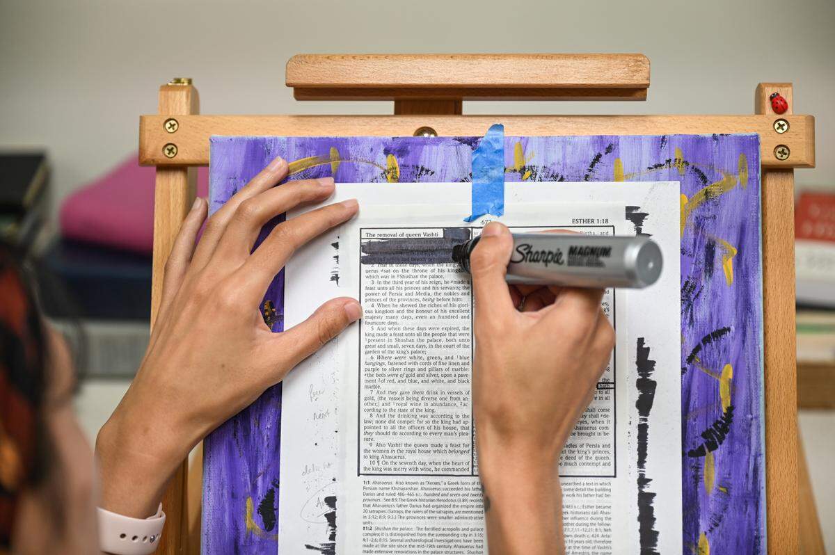 Using a large Sharpie, Caeli Faisst blacks out large sections of pages from the Bible to create poems.