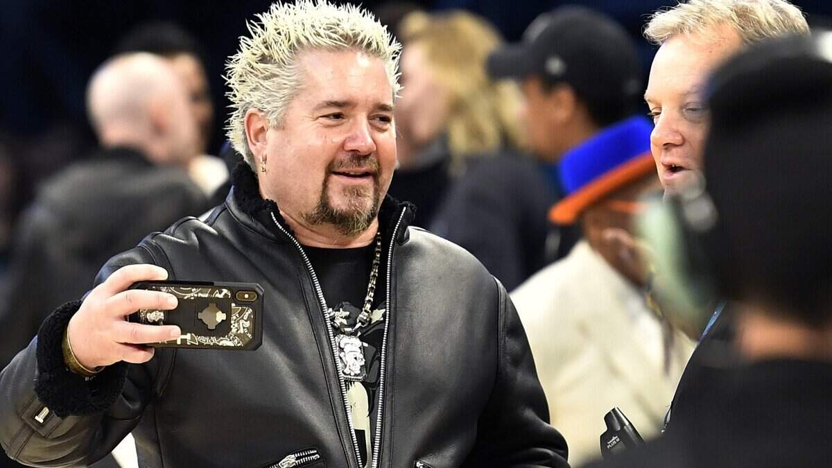 Guy Fieri takes photos on the court during pre-game festivities at the NBA All-Star Game at Spectrum Center in Charlotte on Feb. 17, 2019.