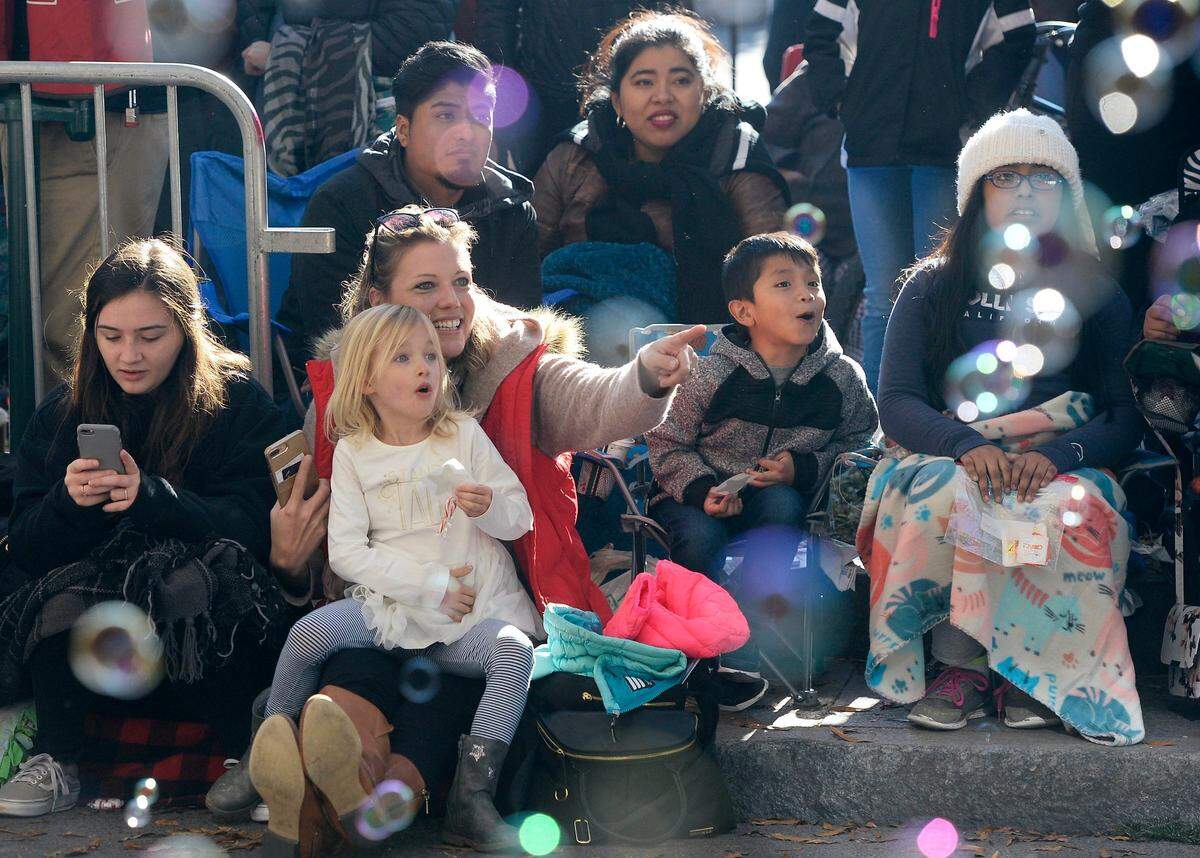 Floating bubbles capture the attention of parade watchers during the 2018 Novant Health Thanksgiving Day Parade along Tryon Street.