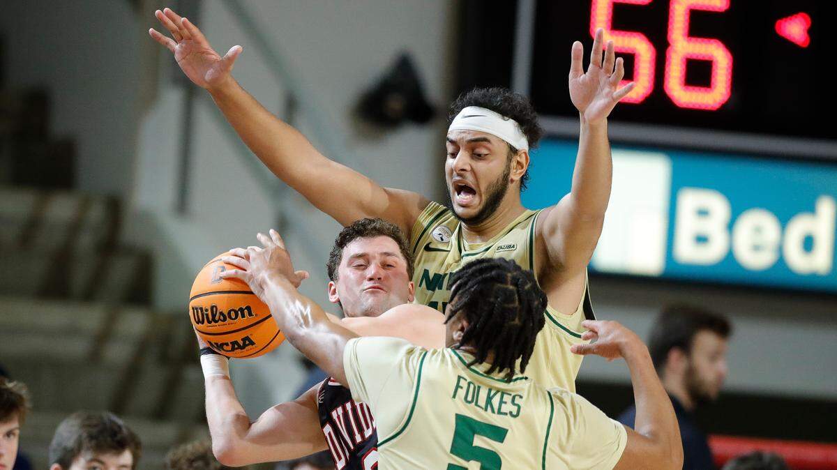 Charlotte 49ers forward Aly Khalifa (15) and Charlotte 49ers guard Isaiah Folkes (5) guard Davidson Wildcats guard Foster Loyer (0) during a game at Belk Arena in Davidson, N.C., Tuesday, Nov. 29, 2022.