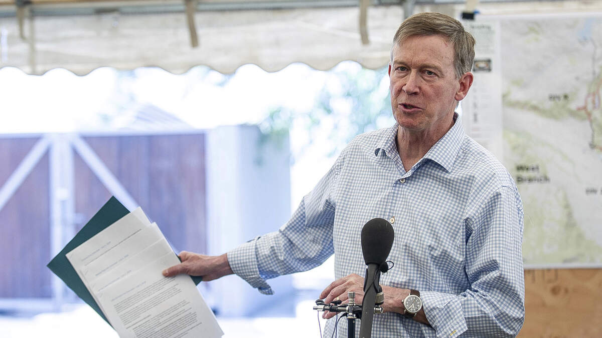 Colorado Gov. John Hickenlooper speaks to reporters about wildfires this month.