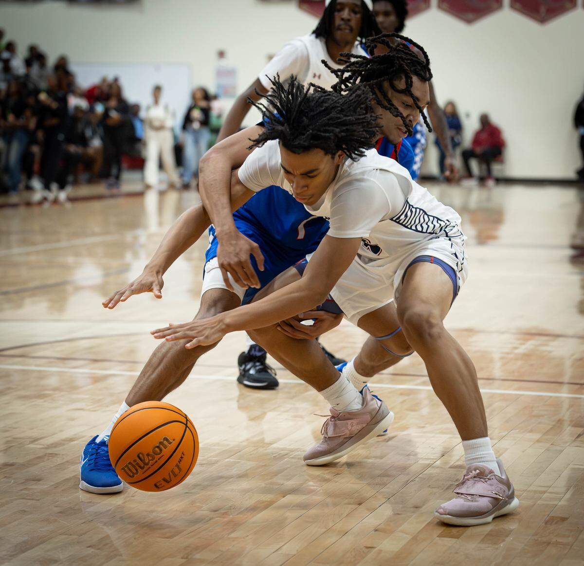 Mallard Creek's Michael Bengue (center) wins the loose ball during early 1st quarter action. Mallard Creek would host the Vikings from North Meck Tuesday January, 6, 2026.