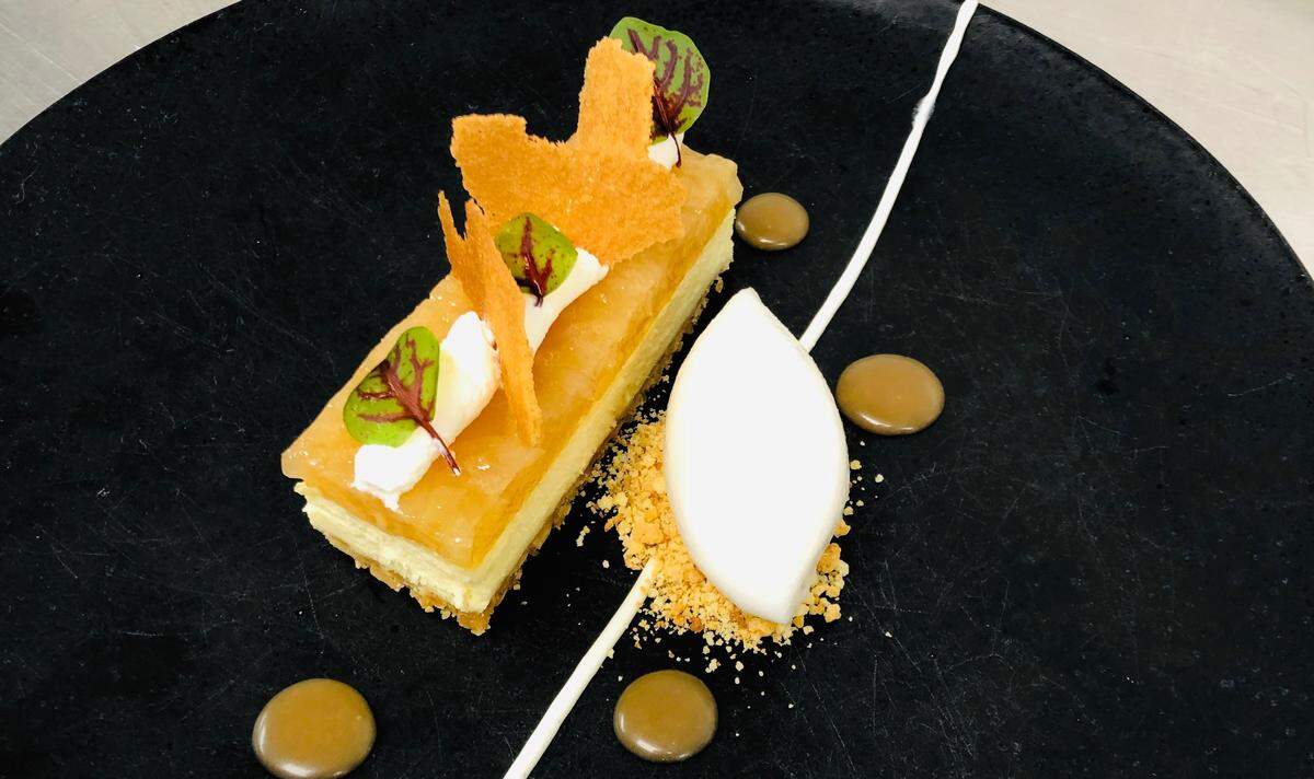 Peppervine's new White Chocolate Cheesecake is made with Amaretti cookie crust, poached pear compote, green chartreuse Chantilly and verjus sorbet.