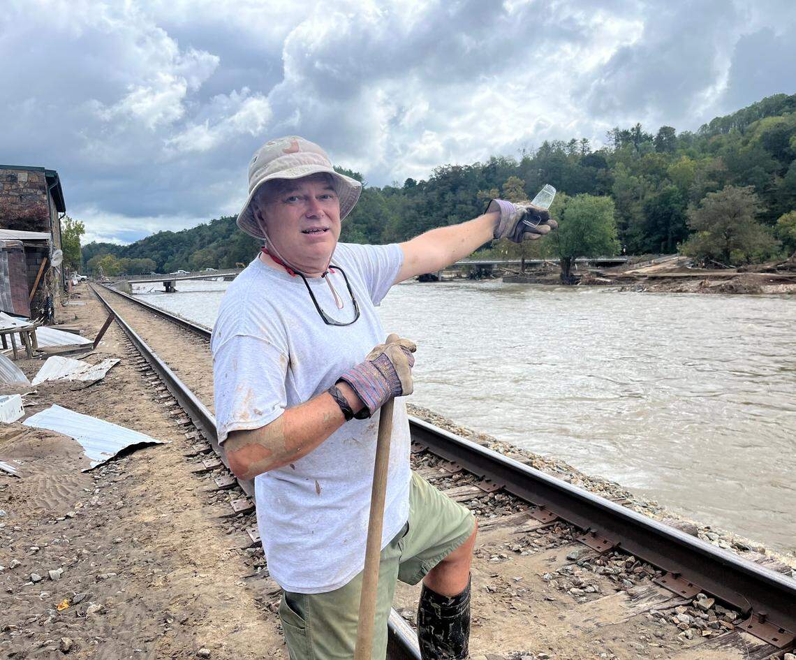 Fran Randall points out some landmarks across the French Broad River in Marshall on Tuesday, Oct. 1, 2024, after Helene devastated the town. He knows Marshall is now a changed place.
