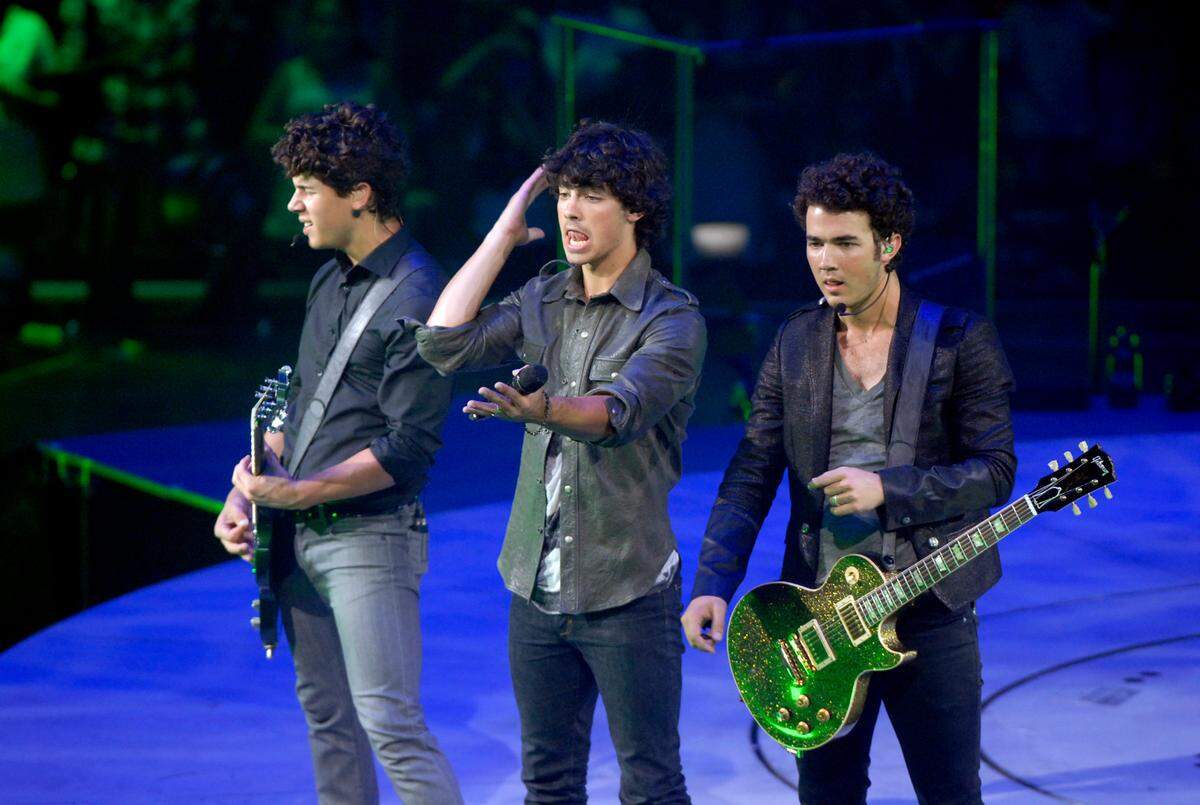  Actors and musicians Nick, Joe and Kevin, of the Jonas Brothers, perform during their concert at Time Warner Cable Arena on Friday, August 21, 2009. YALONDA M. JAMES