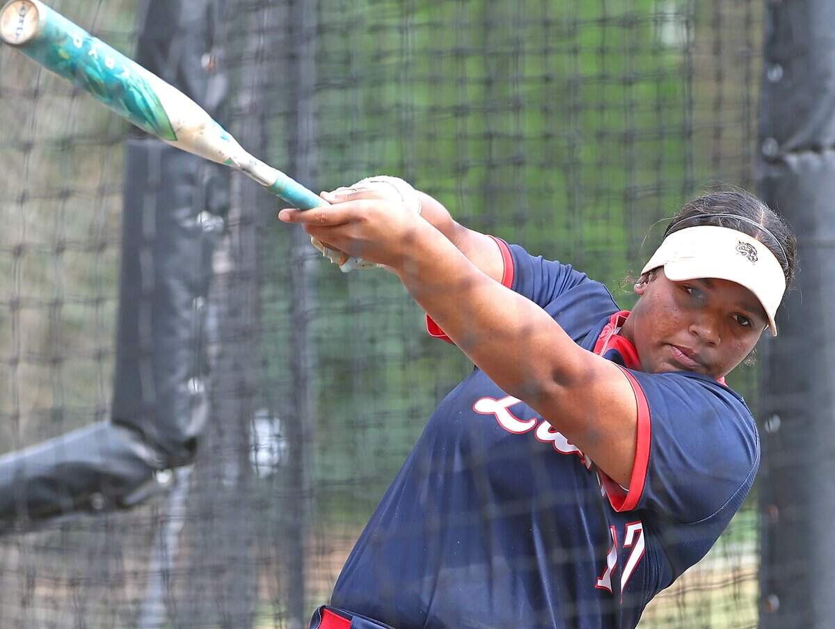 Covenant Day softball player Avery Houseton follows through on her swing while hitting off a tee during practice on Wednesday, April 1, 2026. Houseton is planning on playing softball for the Charlotte 49ers.