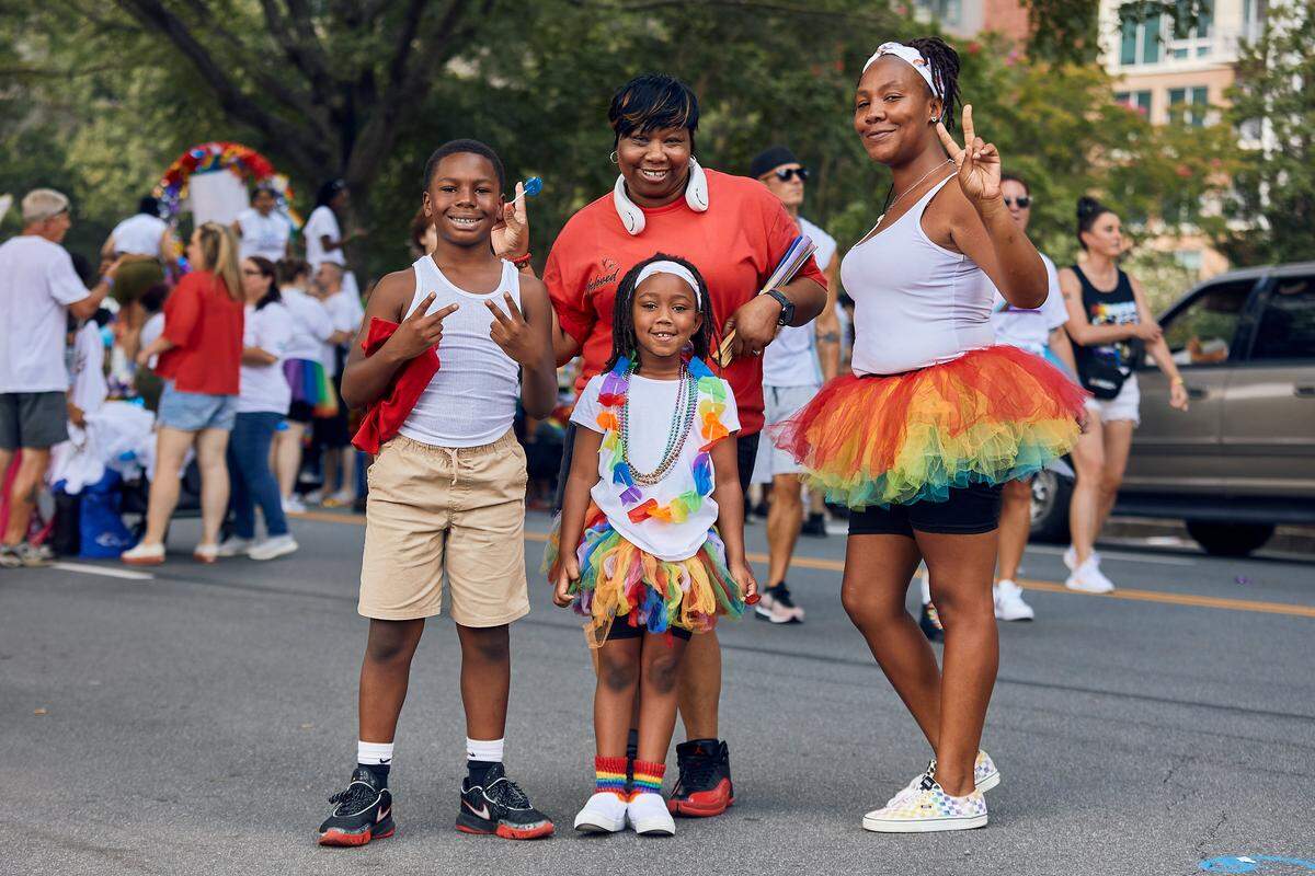 Families take in the sights and sounds during the 25th Charlotte Pride Parade in uptown Charlotte on August 17, 2025.