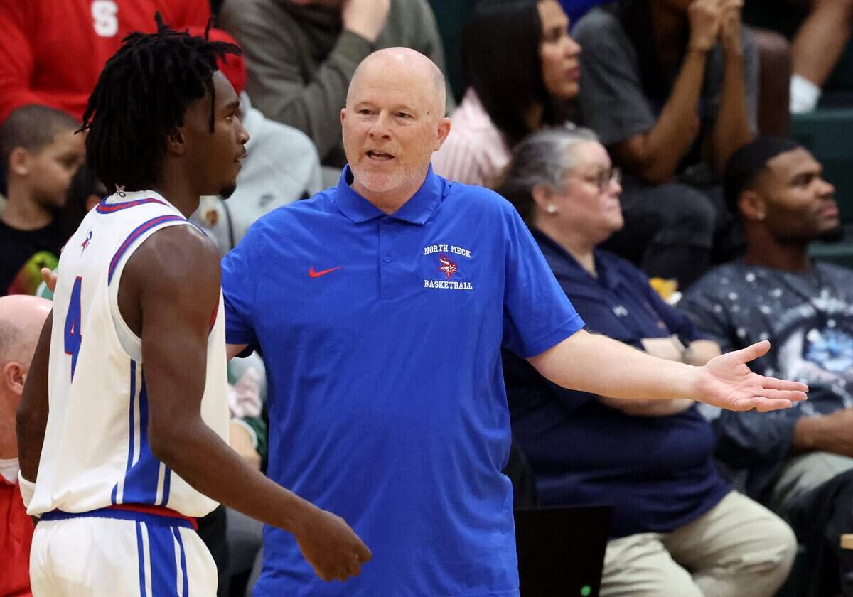 North Meck boys basketball coach Duane Lewis talks with guard Ashton Pierce during action against West Charlotte in the Power Six Conference Tournament action on Feb. 20, 2026 at Independence High School. North Meck defeated West Charlotte, 71-56.