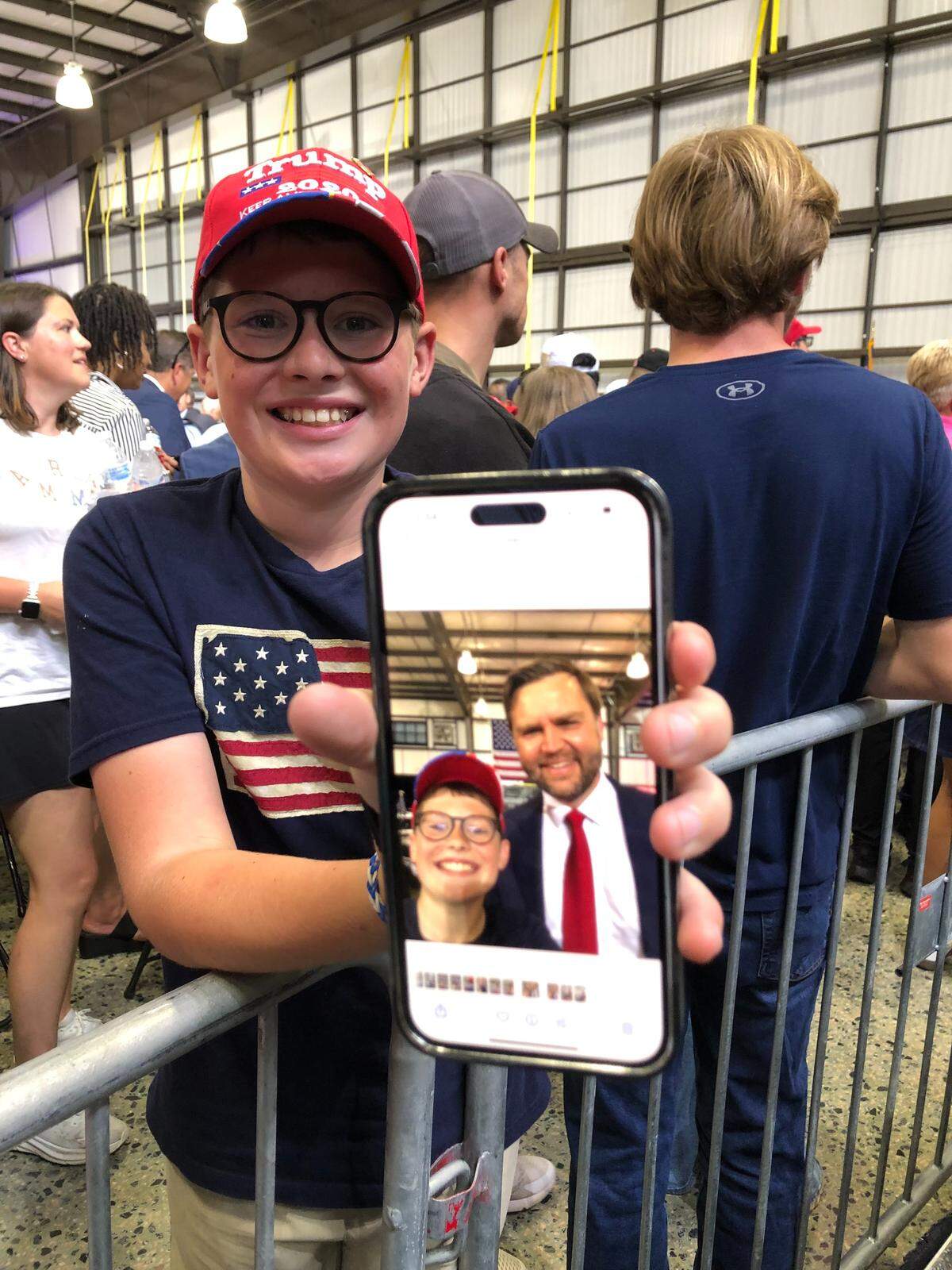 12-year-old Henry James, of Huntersville, NC., shows the selfie he shot of himself with Vice President JD Vance during the vice president’s speech at Concord Padgett Regional Airport in Concord, NC on Wednesday, September 24, 2025.