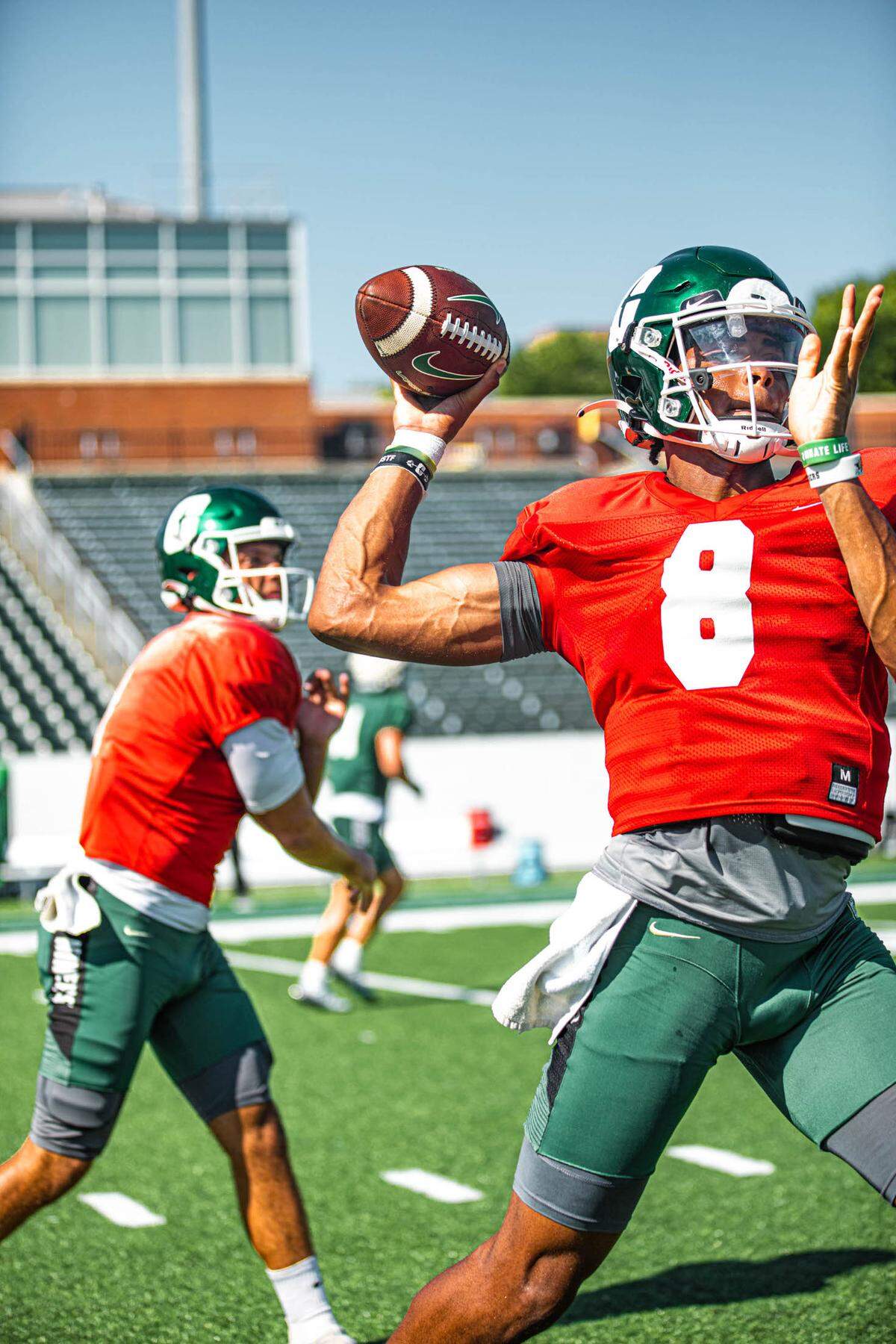 Charlotte 49ers quarterbacks Xavier Williams (8) and Chris Reynolds throw during a recent practice.