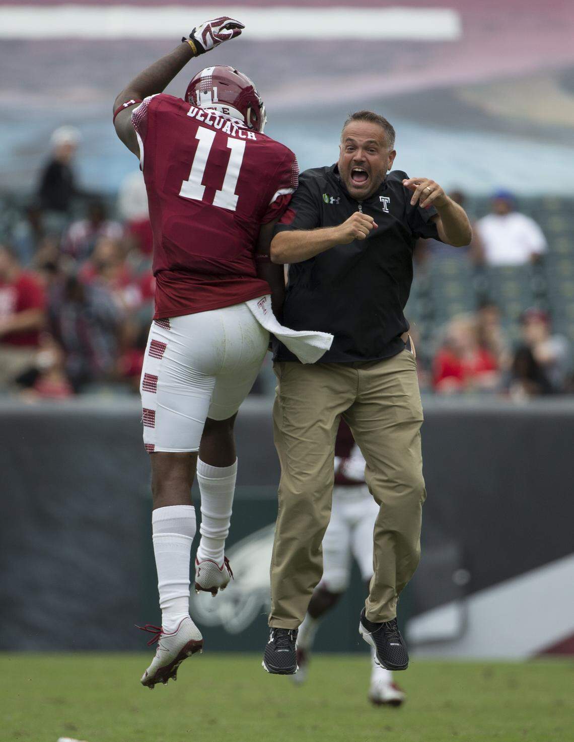 Romond Deloatch of the Temple Owls celebrates with his coach Matt Rhule against the Charlotte 49ers in 2016. Rhule helped turn the Temple program around after asking former coach Al Golden to hire him as an assistant. (Photo by Mitchell Leff/Getty Images)