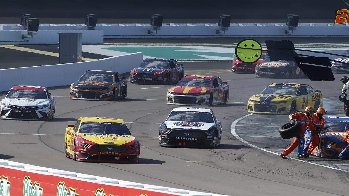 Joey Logano (22), Kevin Harvick (4) and other drivers exit pit road after pit stops during a NASCAR Cup Series auto race at Phoenix Raceway, Sunday, March 8, 2020, in Avondale, Ariz. (AP Photo/Ralph Freso)