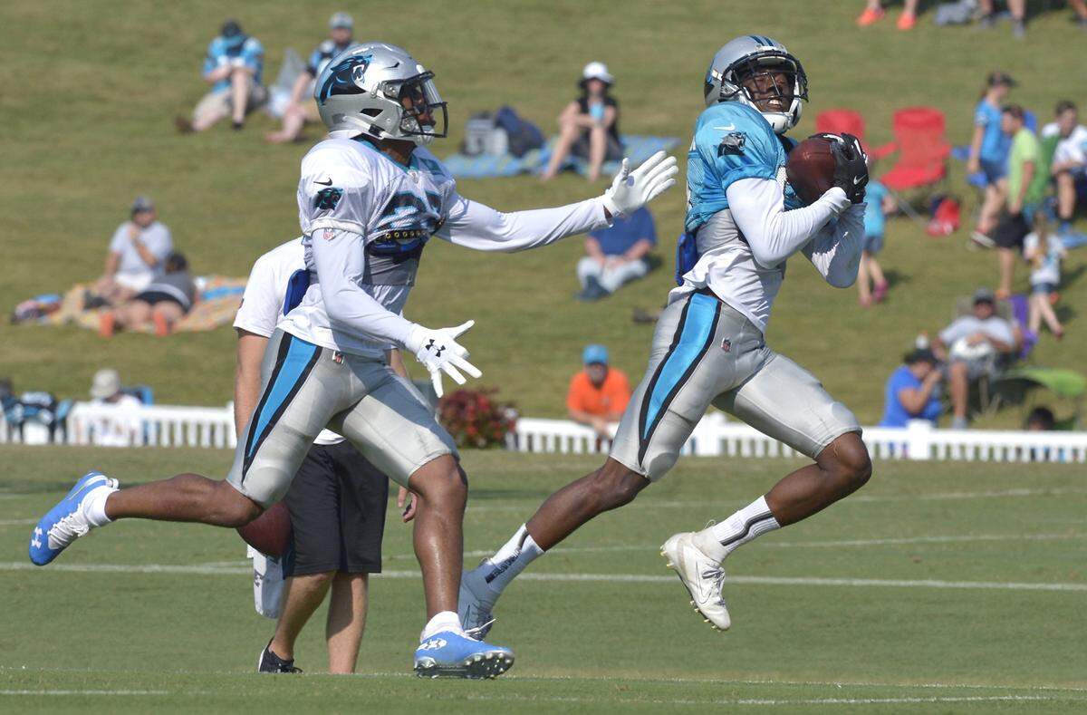 Carolina Panthers wide receiver Damion Jeanpiere Jr., right, hauls in a deep pass in front of cornerback Josh Thornton during practice on Thursday at Wofford College in Spartanburg, S.C.