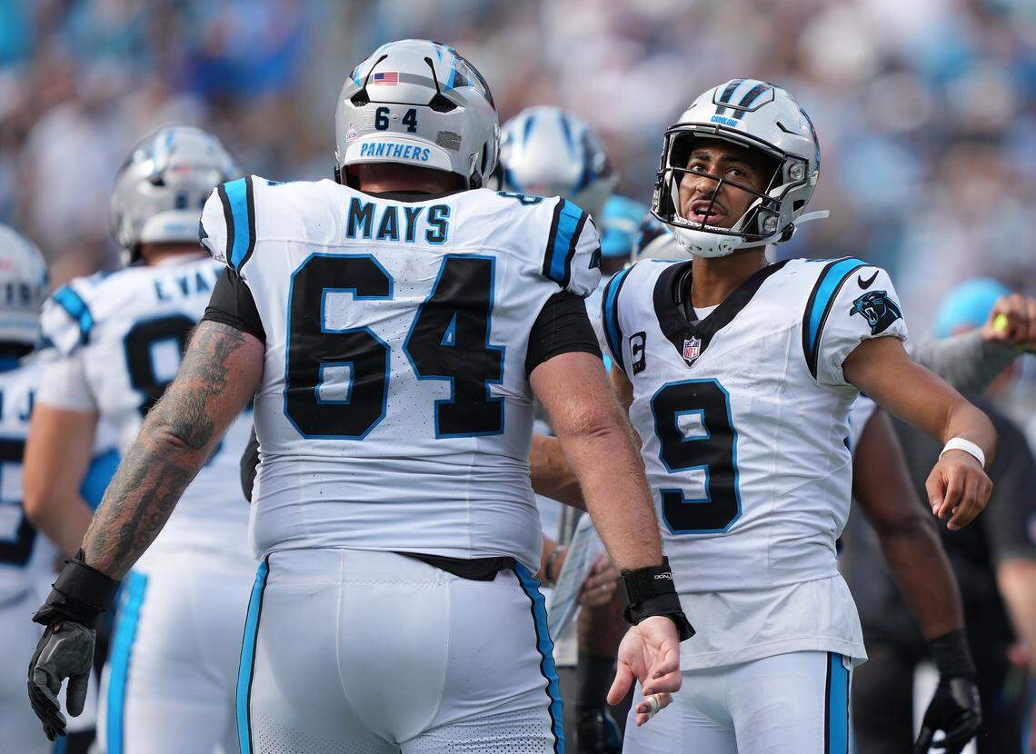 Carolina Panthers quarterback Bryce Young, right, and center Cade Mays react in their Oct. 5, 2025 game against the Miami Dolphins at Bank of America Stadium.