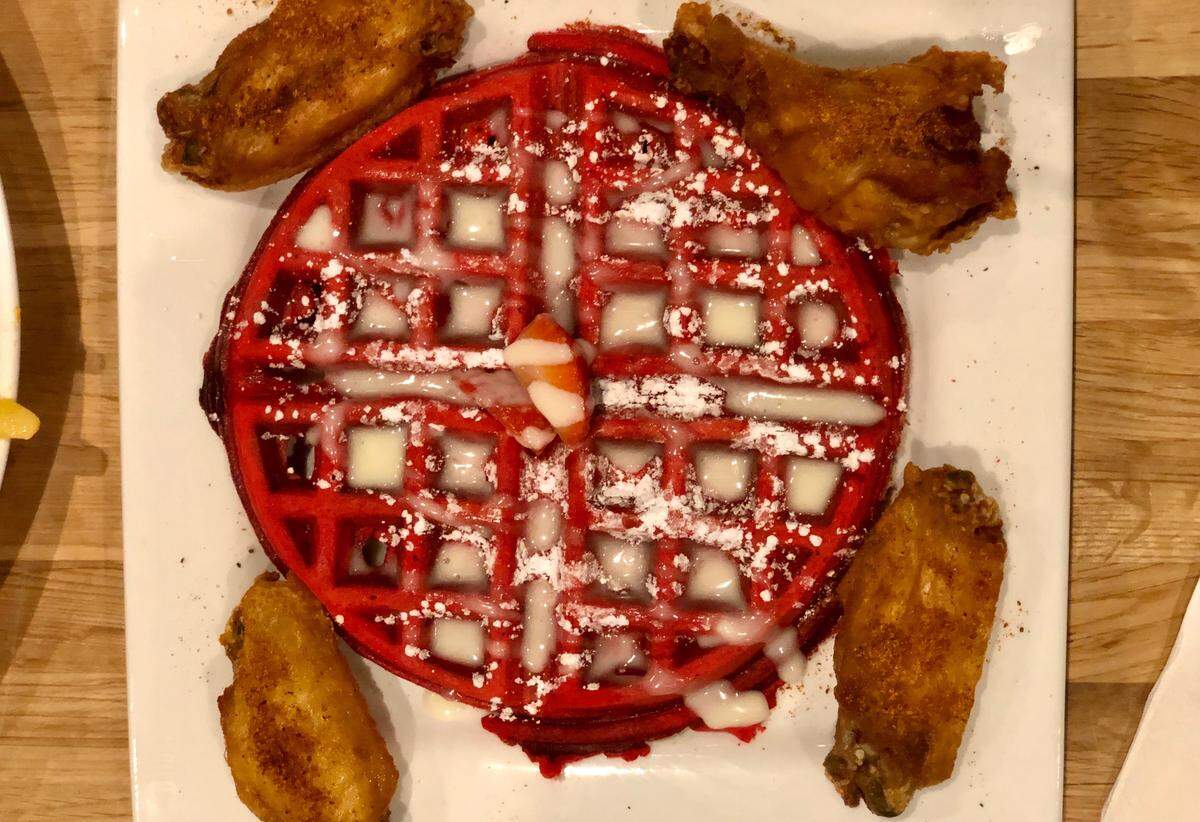 Cuzzo's red velvet waffle is available with chicken as a meal or alone as a dessert.