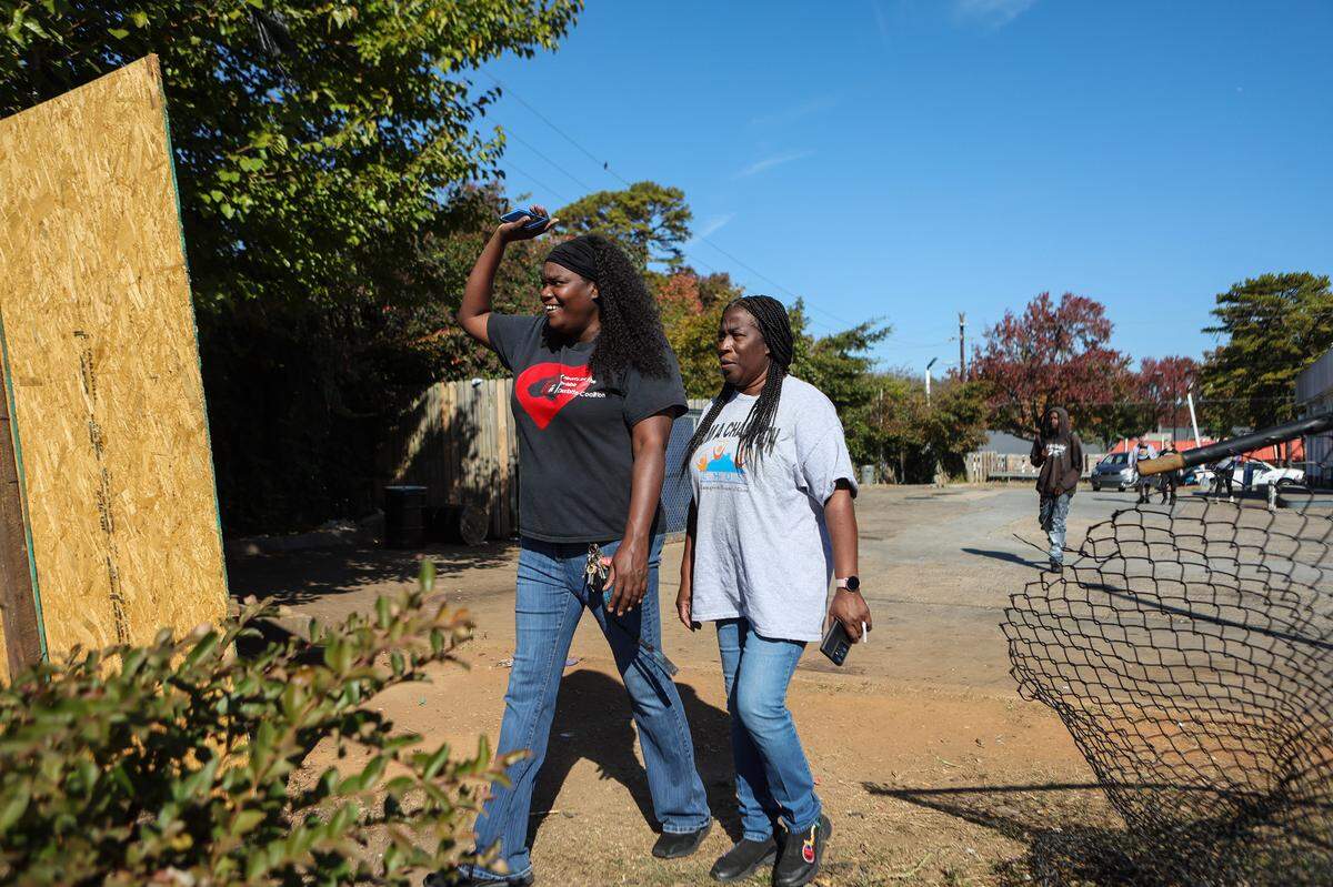 Last October, three nonprofits collaborated to bring resources to around 200 people without housing on Sugar Creek Road, a community adjacent to Hidden Valley. One of the nonprofits was Hearts for the Invisible Charlotte Coalition, headed by Jessica Lefkowitz, left, a Hidden Valley resident. During a health fair for the unhoused in the Sugar Creek Corridor, Lefkowitz walks around several blocks informing people of the fair and encourages them to visit.