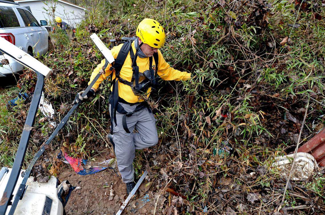 A member of the Charlotte Fire rescue team walks along dense overgrowth at the Hiddenite Family Campground in Hiddenite, NC on Friday, November 13, 2020. Rescue personnel found the body of a male shortly after 11 a.m. on Friday. The campground is located along the Yadkin River.