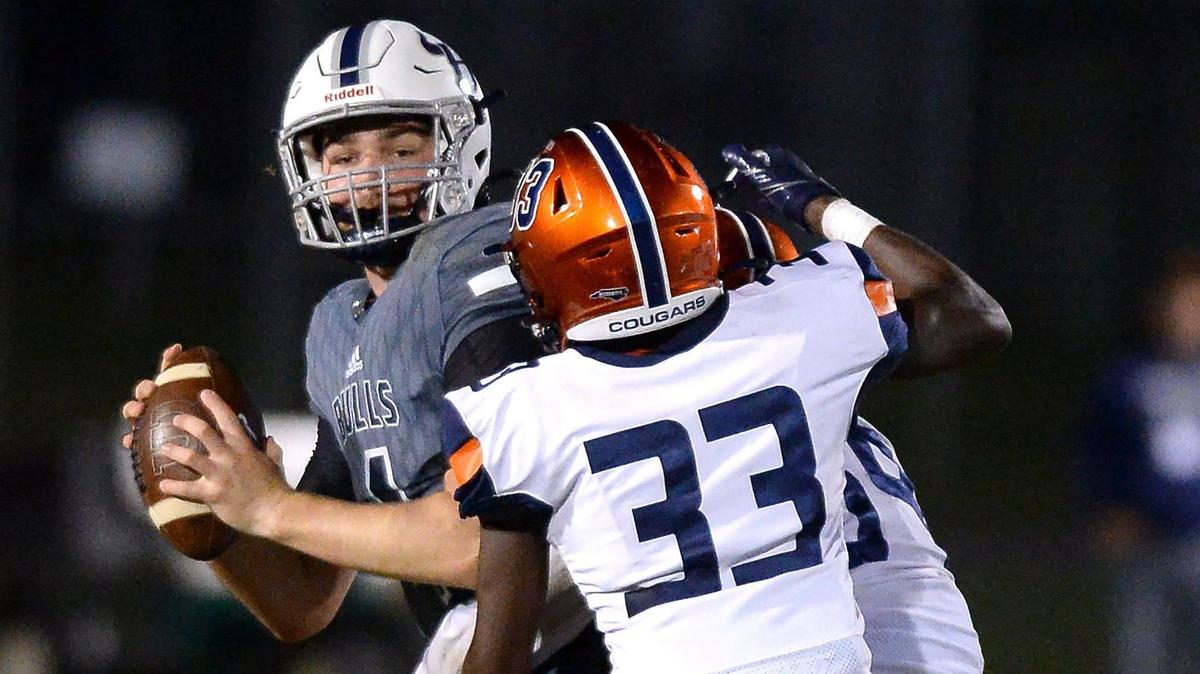 Hickory Ridge quarterback Caden Haywood back peddles as the Chambers High Cougars defense swarms him for a sack during second quarter action on Friday, September 9, 2022.