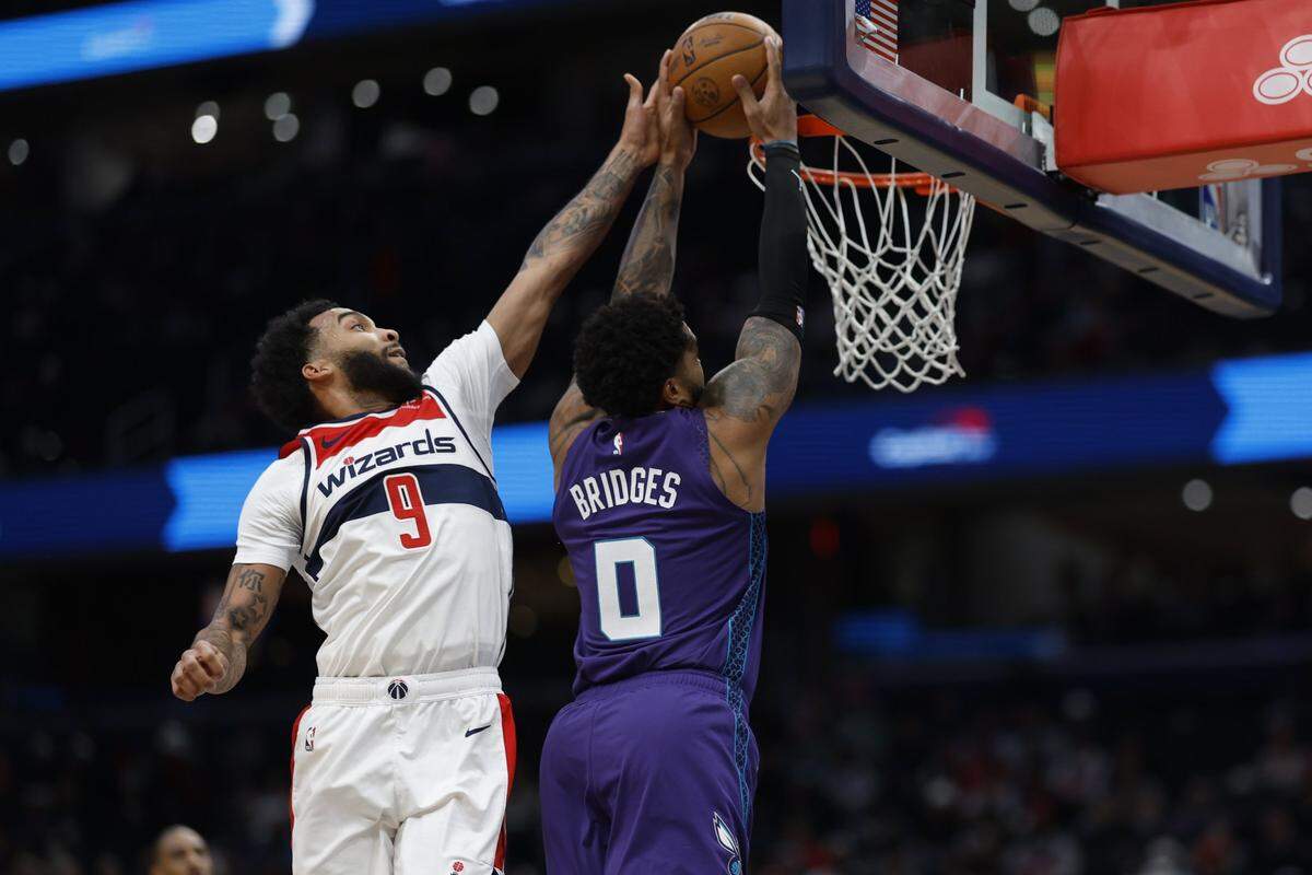 Charlotte Hornets forward Miles Bridges (0) attempts to dunk the ball as Washington Wizards forward Justin Champagnie (9) defends in the first quarter at Capital One Arena.