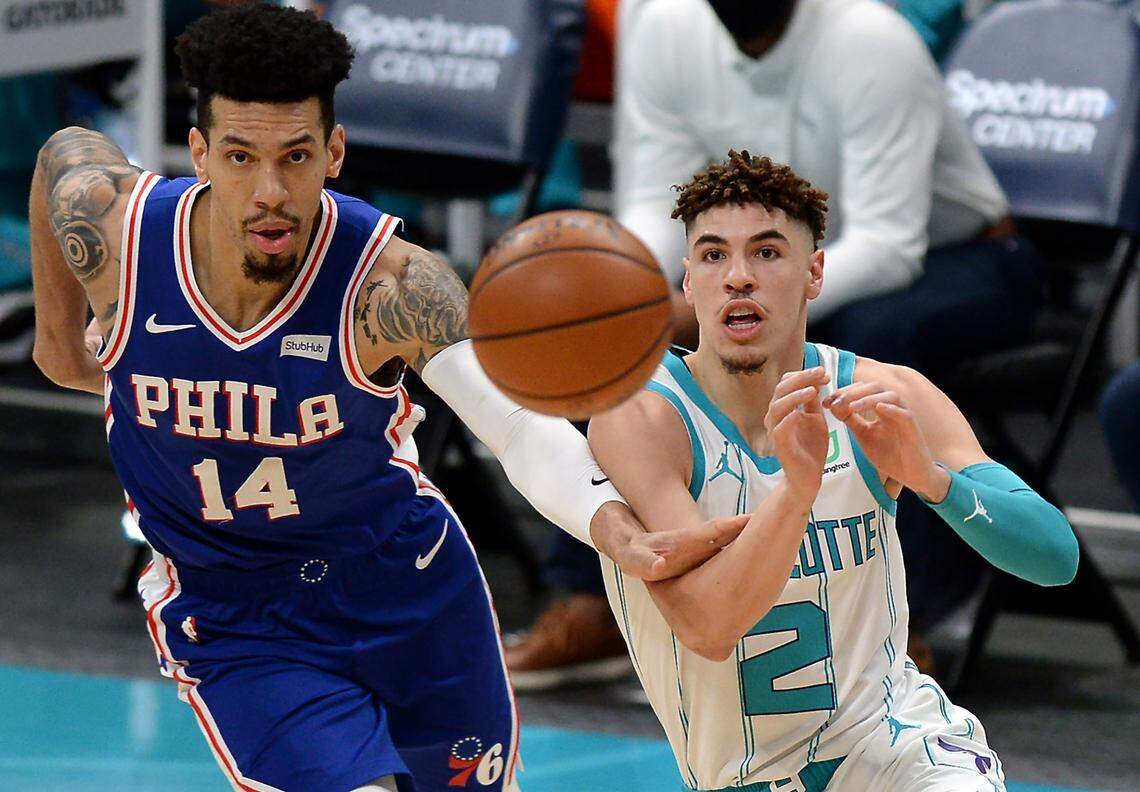 Charlotte Hornets guard LaMelo Ball, right, passes to a teammate as Philadelphia 76ers guard Danny Green, left, chases him on Feb. 3rd.