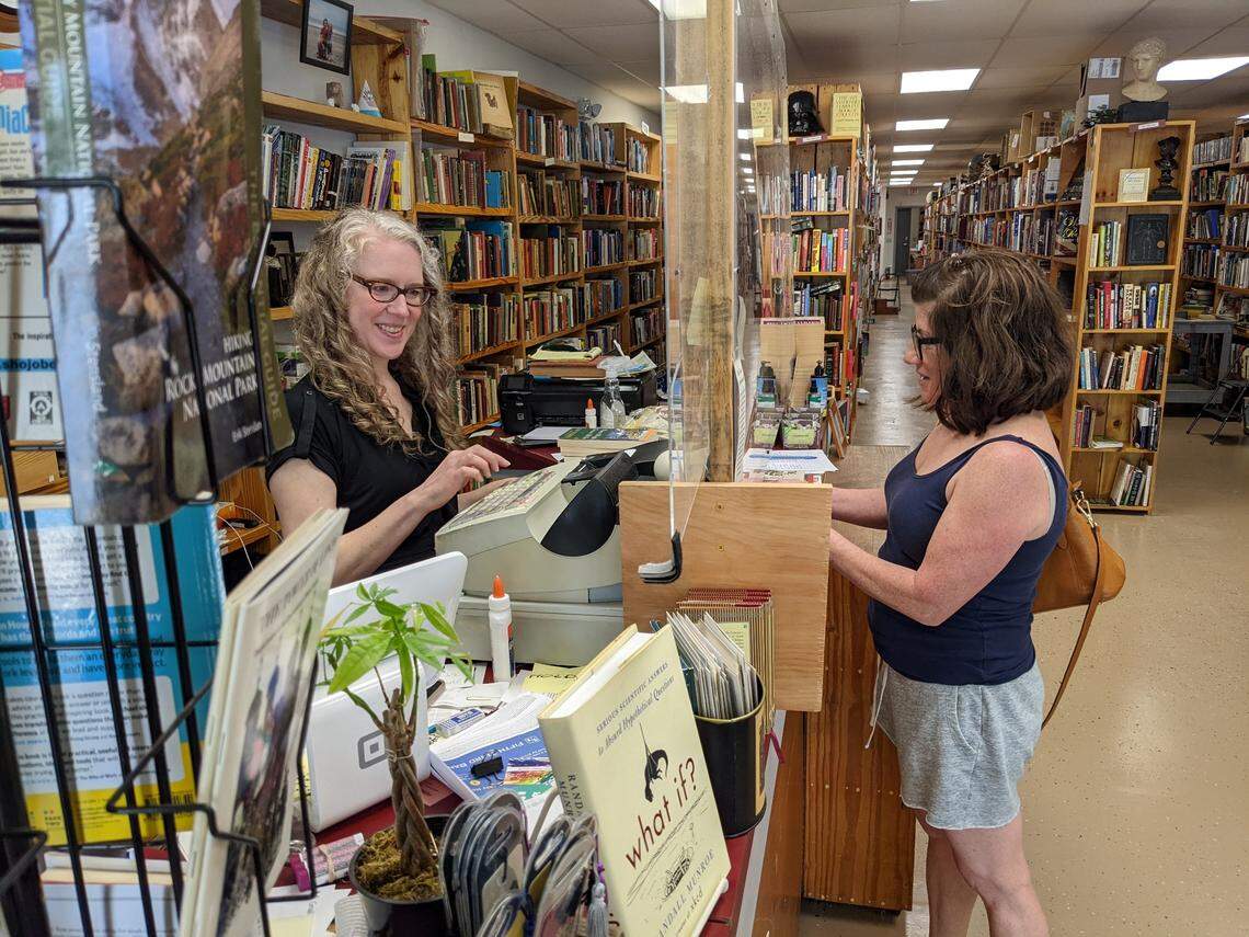 Lee Rathers checks out Therese Bartholomew at Book Buyers new 3040 Eastway Drive, Suite B, location in Charlotte’s Plaza Midwood neighborhood.